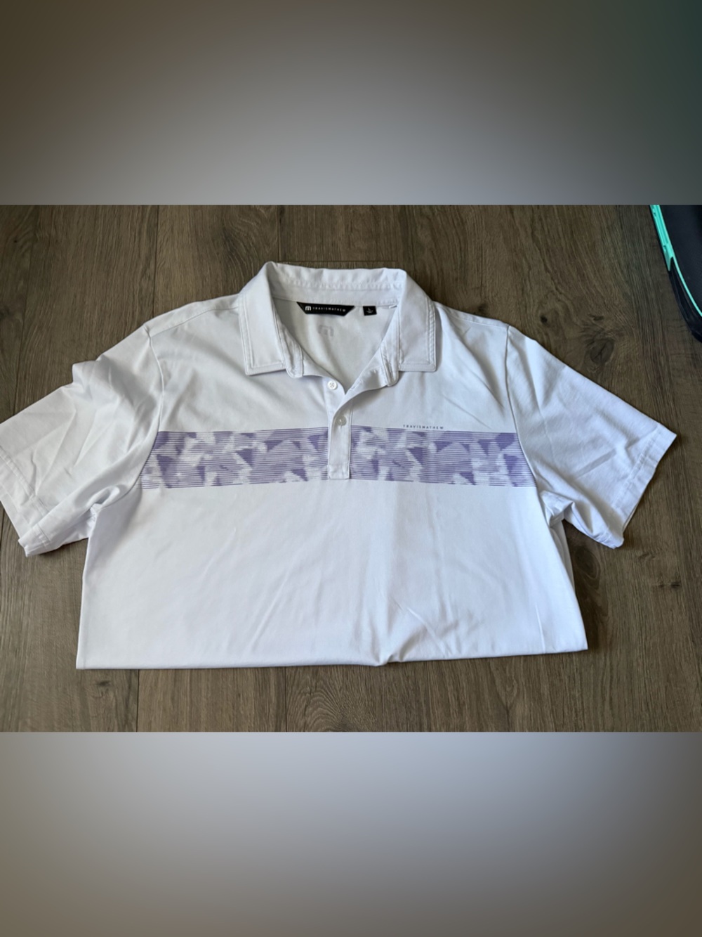 Travis Mathew White Polo with Lavender Chest Stripe